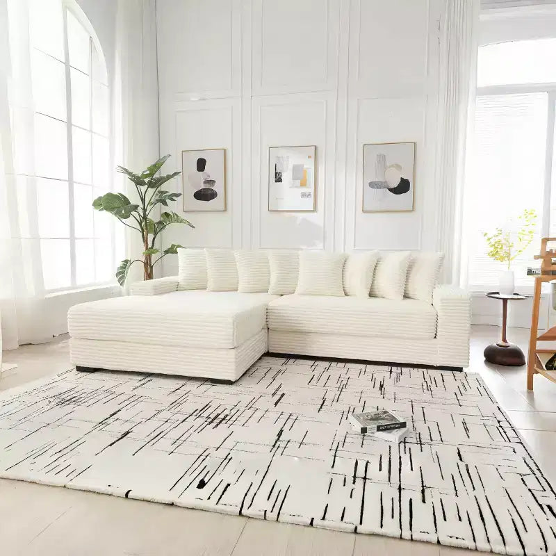 Canapé d'angle en velours côtelé et bois GDFStudio Isabel 111 avec huit oreillers