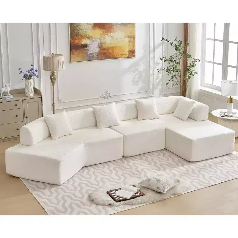 Canapé d'angle moderne 4 places en bouclette GDFStudio Arvik 140 avec 4 coussins